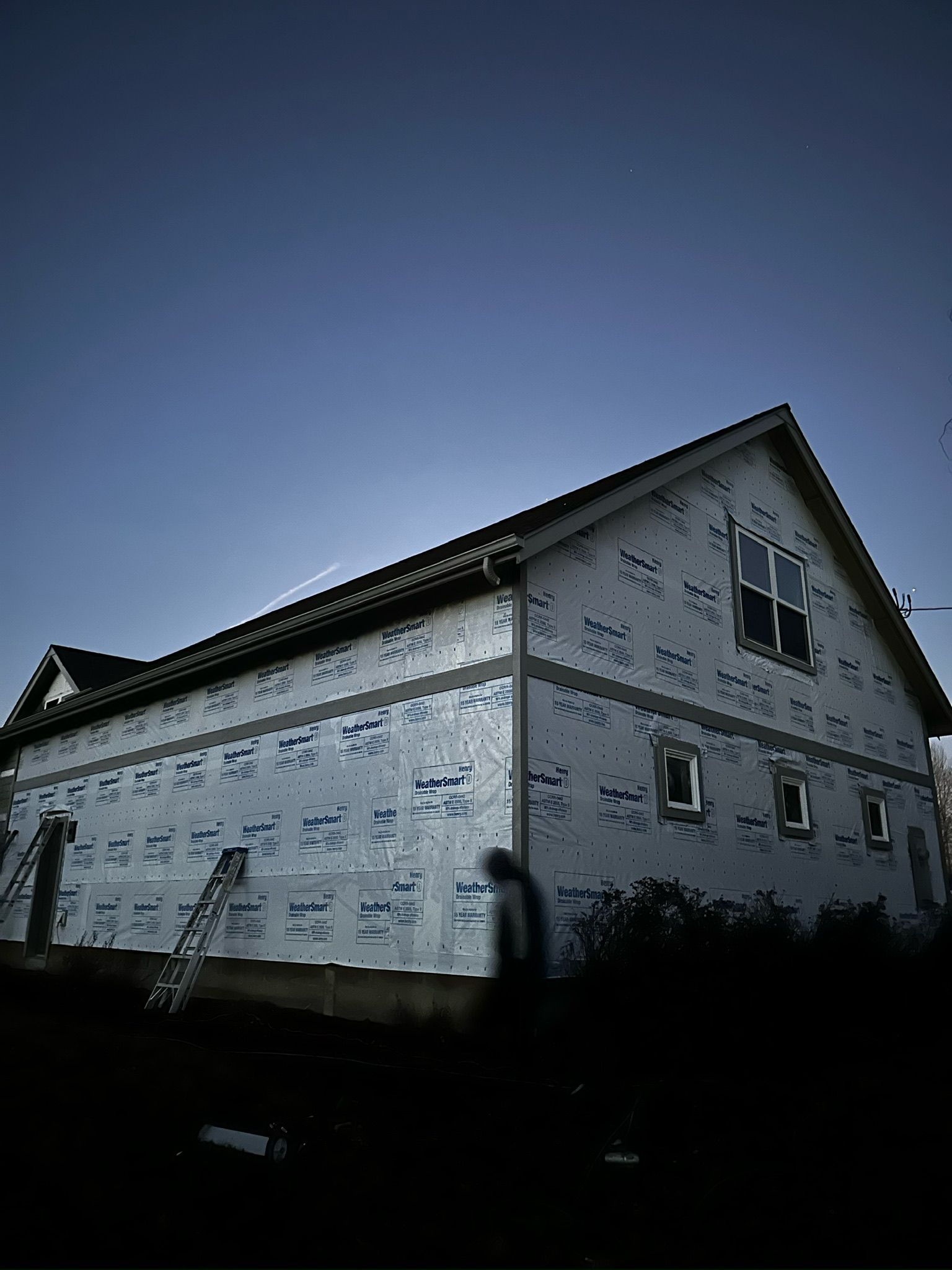 A house is being built with a blue sky in the background.
