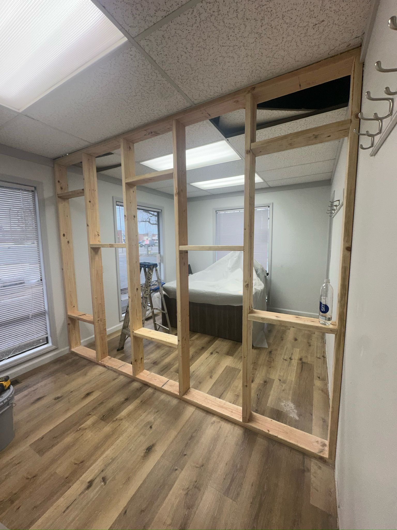 A room with a wooden wall and a bed in it.