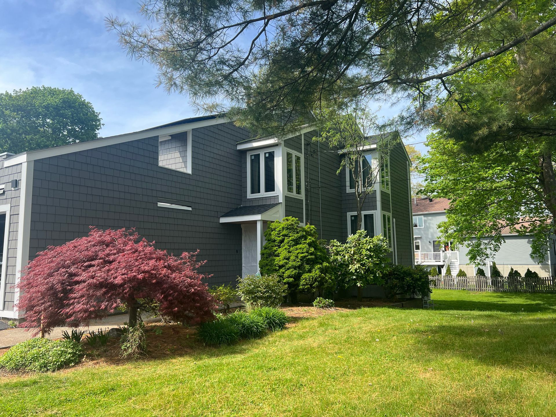 A large house with a lush green lawn in front of it.