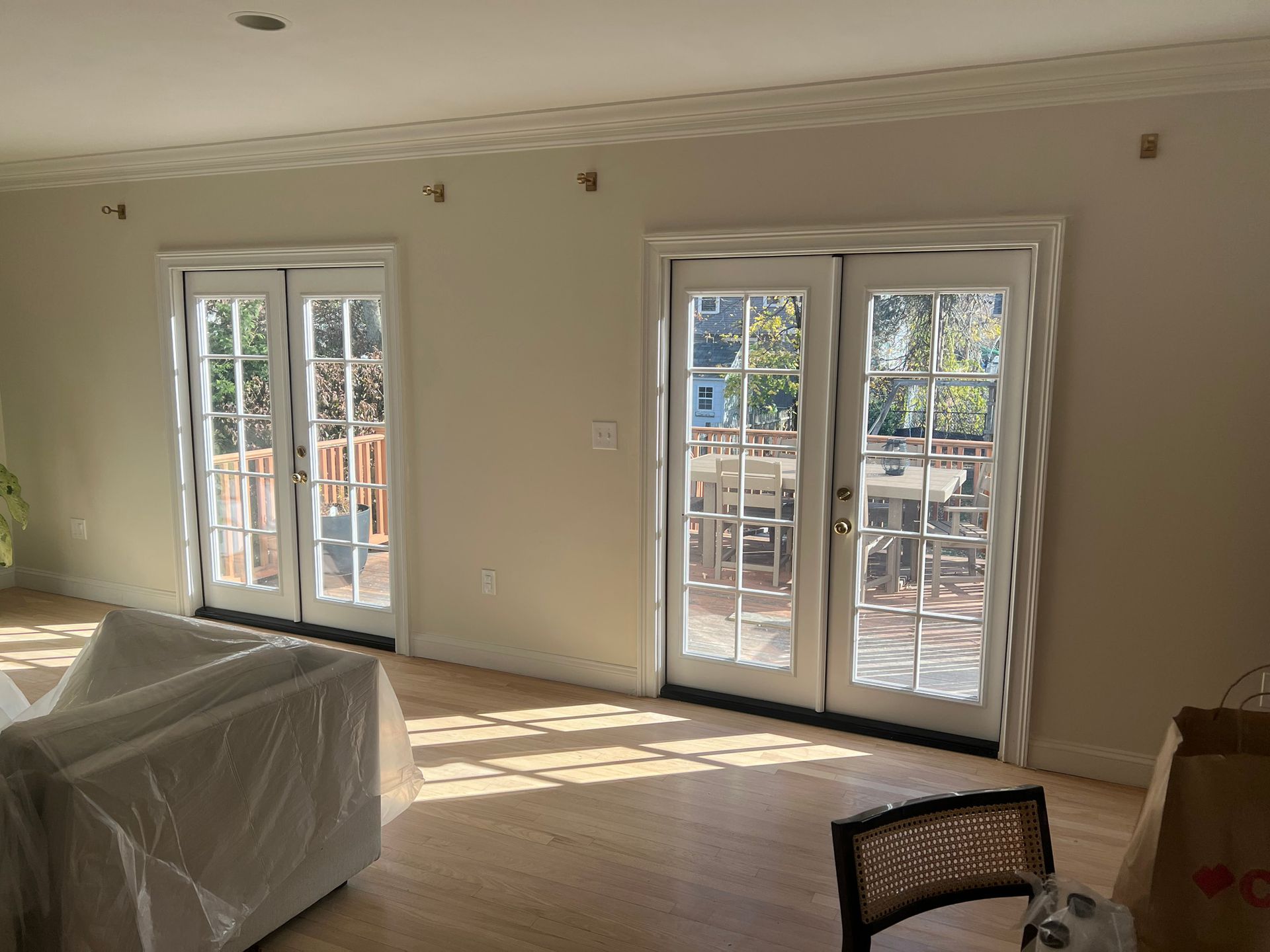 A living room with a couch , chair , and sliding glass doors.