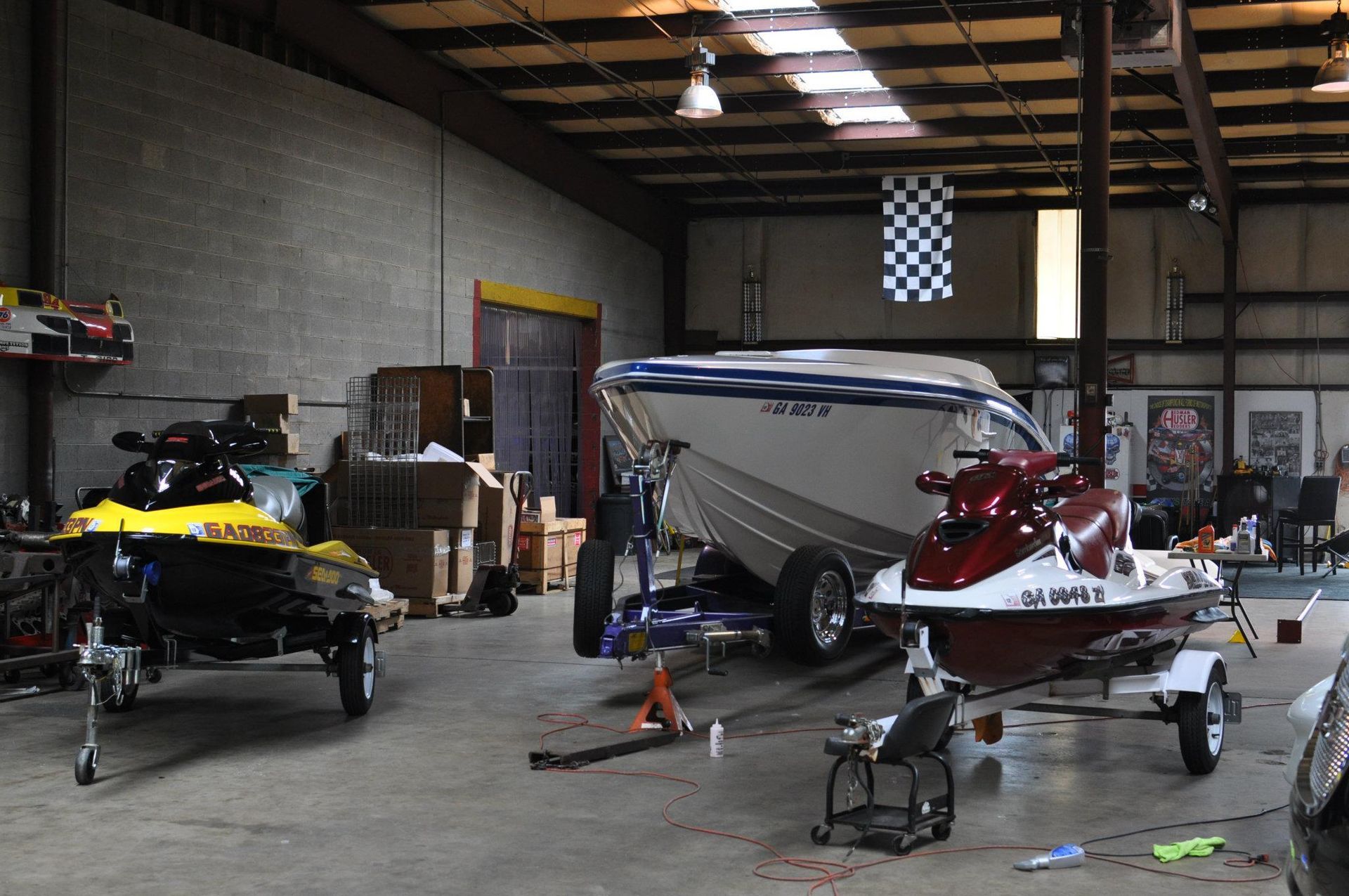 Jet skis and boat inside detailing shop for marine cleaning services