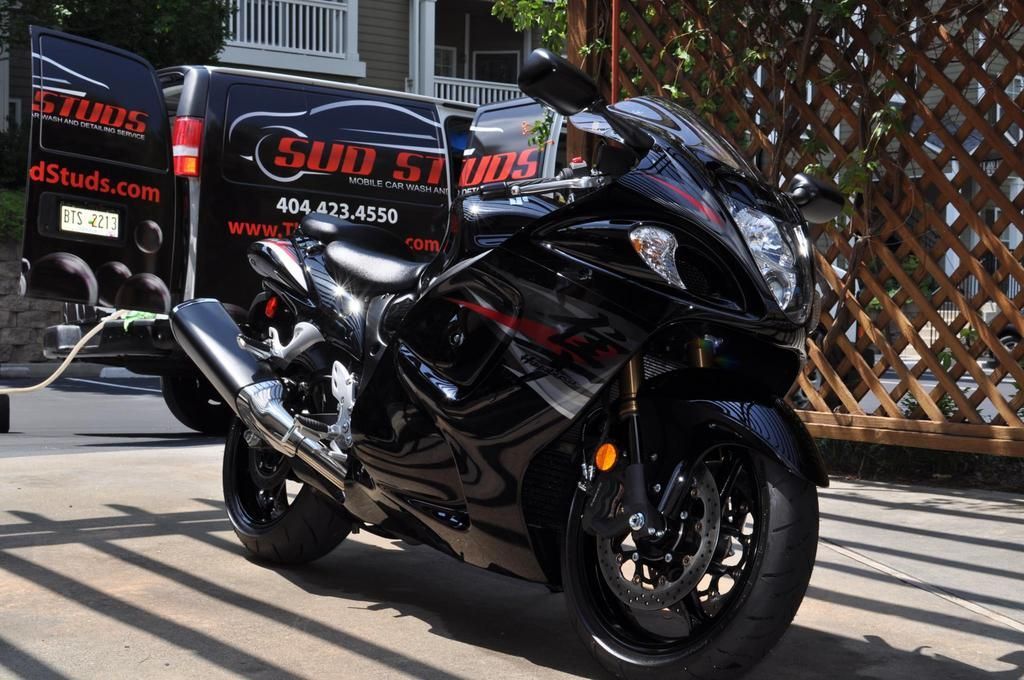 Black sport motorcycle with glossy finish from professional detailing