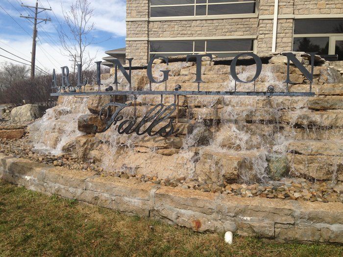 A waterfall in front of a sign that says ington falls