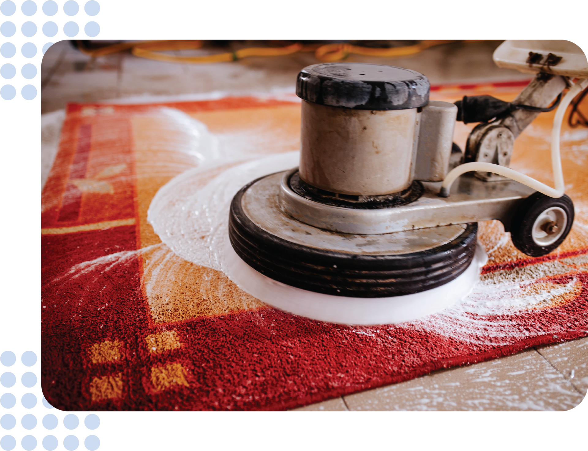 A machine is cleaning a red rug on a tiled floor.