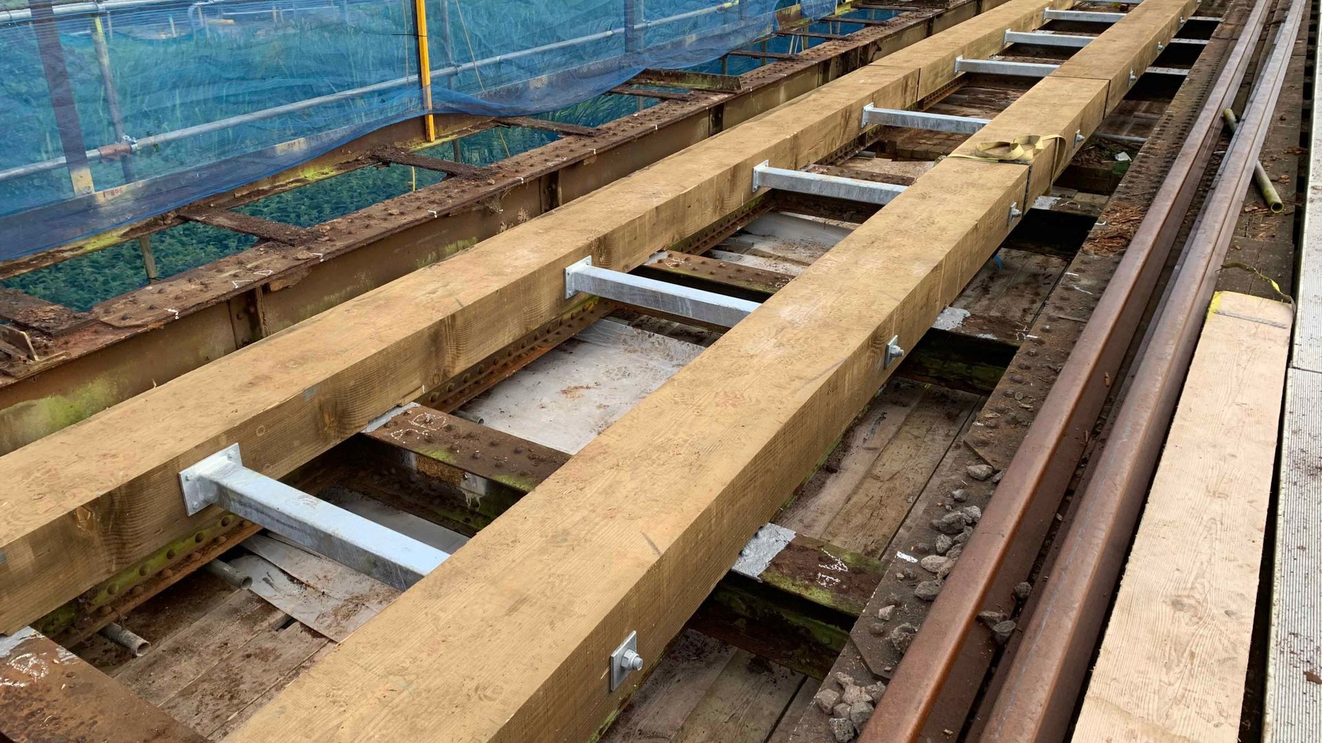 A wooden beam is sitting on top of a train track.