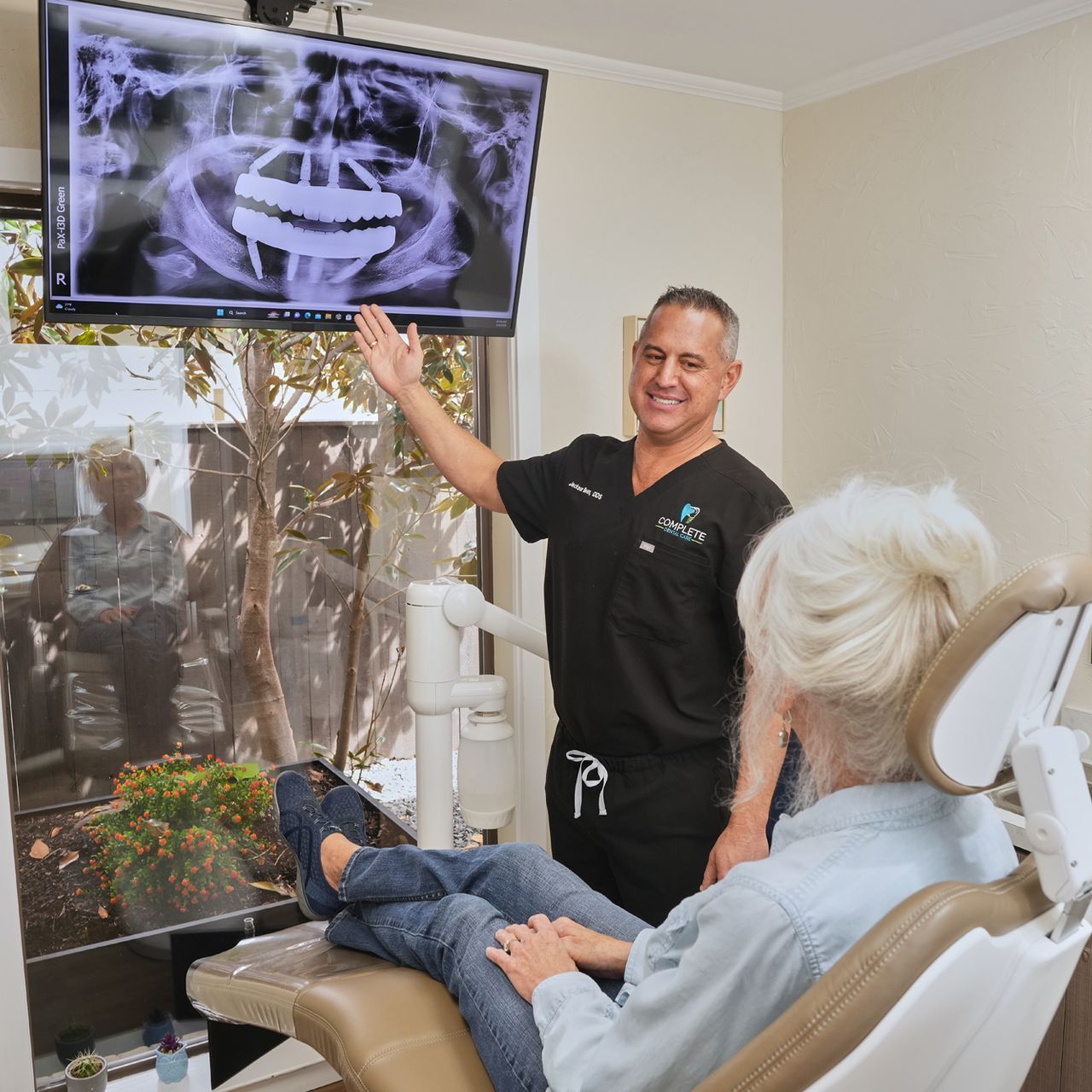 Two women posing for a picture with one wearing a shirt that says mary cats