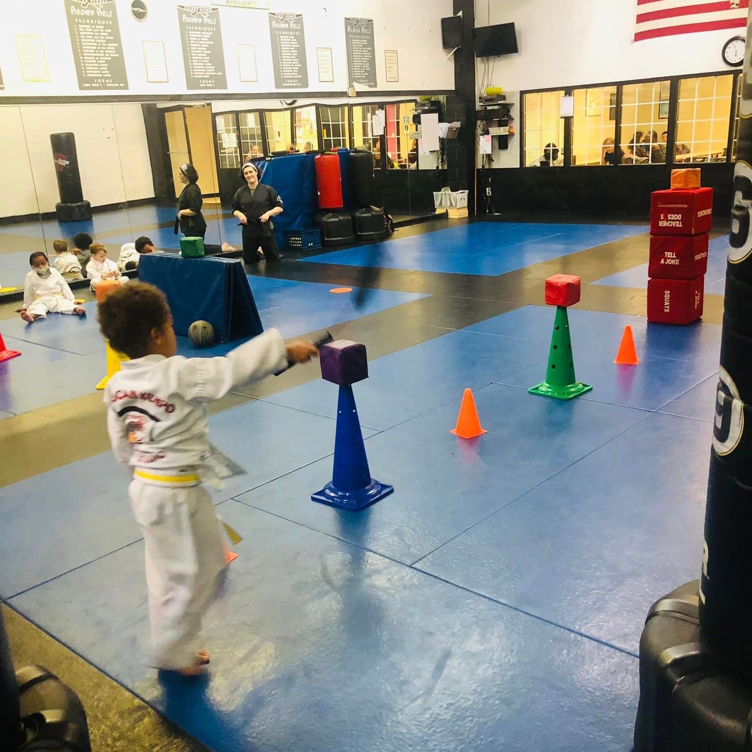 Kids practicing self-defense moves in martial arts class