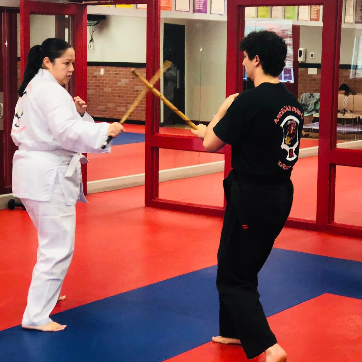 a man wearing a black shirt that says american karate