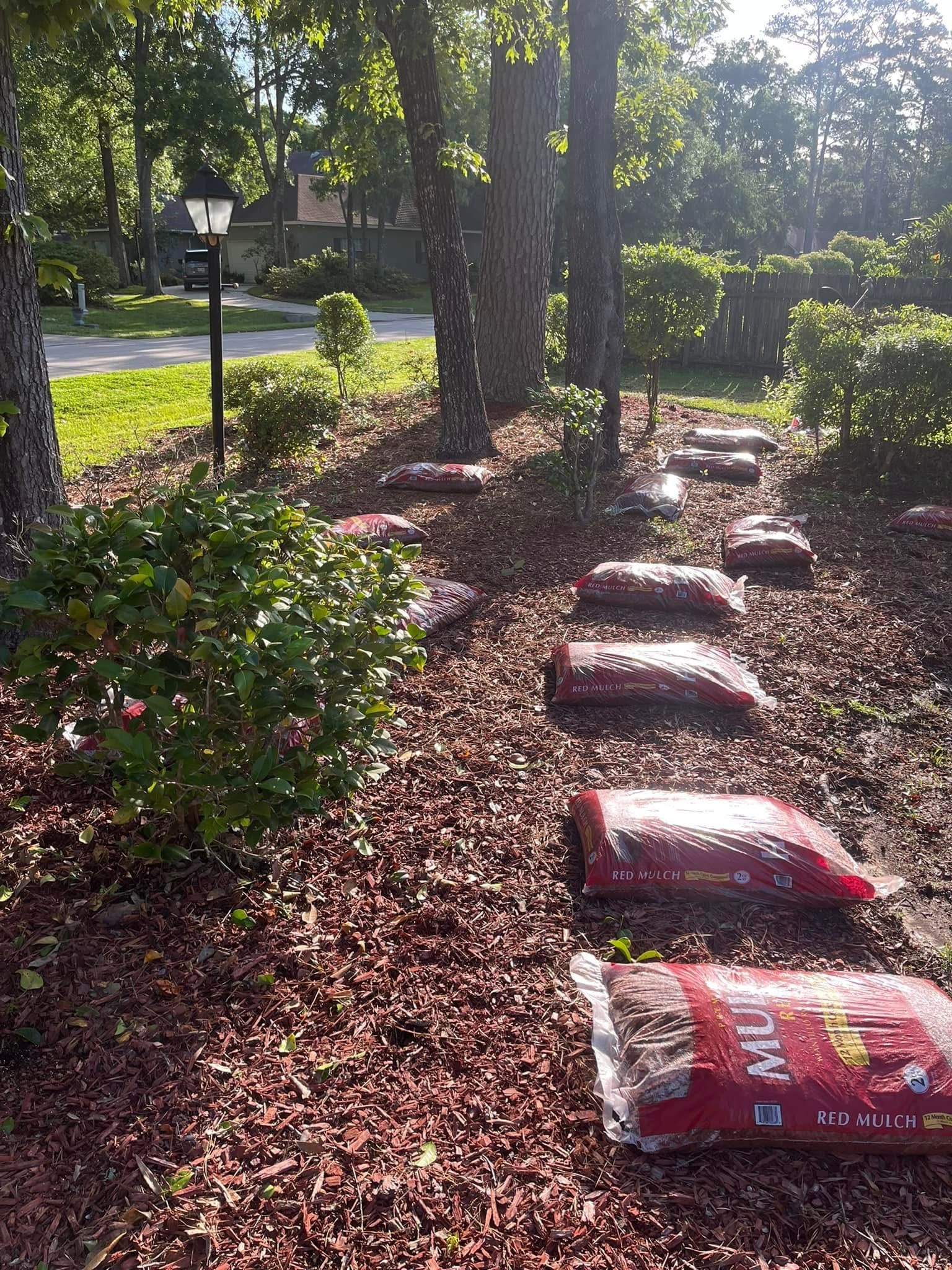 A bunch of bags of mulch are sitting on top of a pile of mulch.