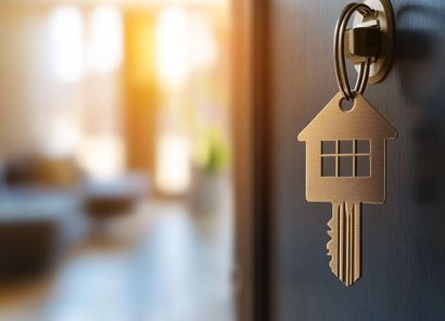 Stock photo of a key opening a door