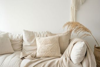 Stock photo of a couch with soft pillows and a blanket