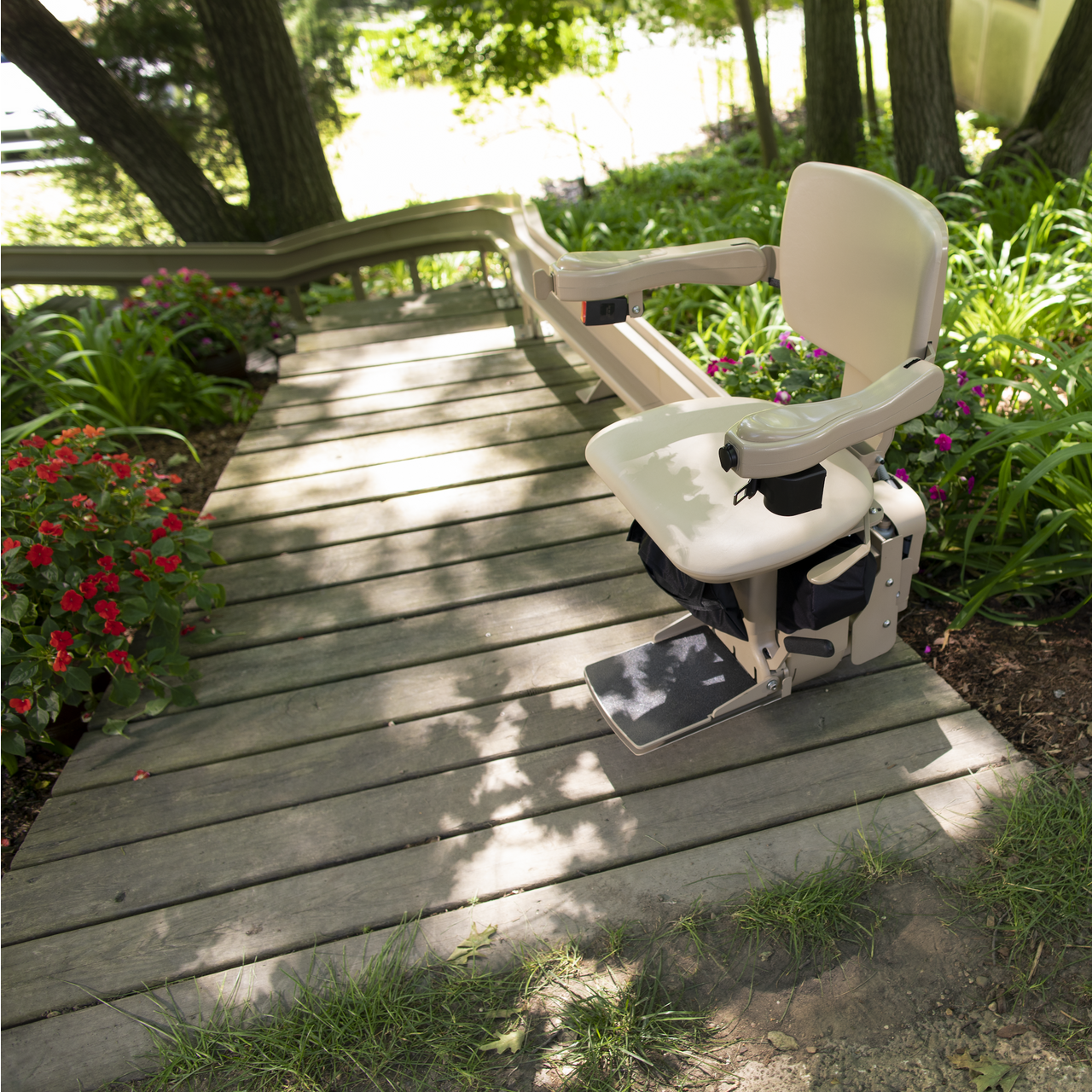 A stair lift is sitting next to a set of stairs