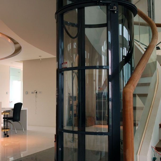 A stair lift with a gray seat and a wooden railing