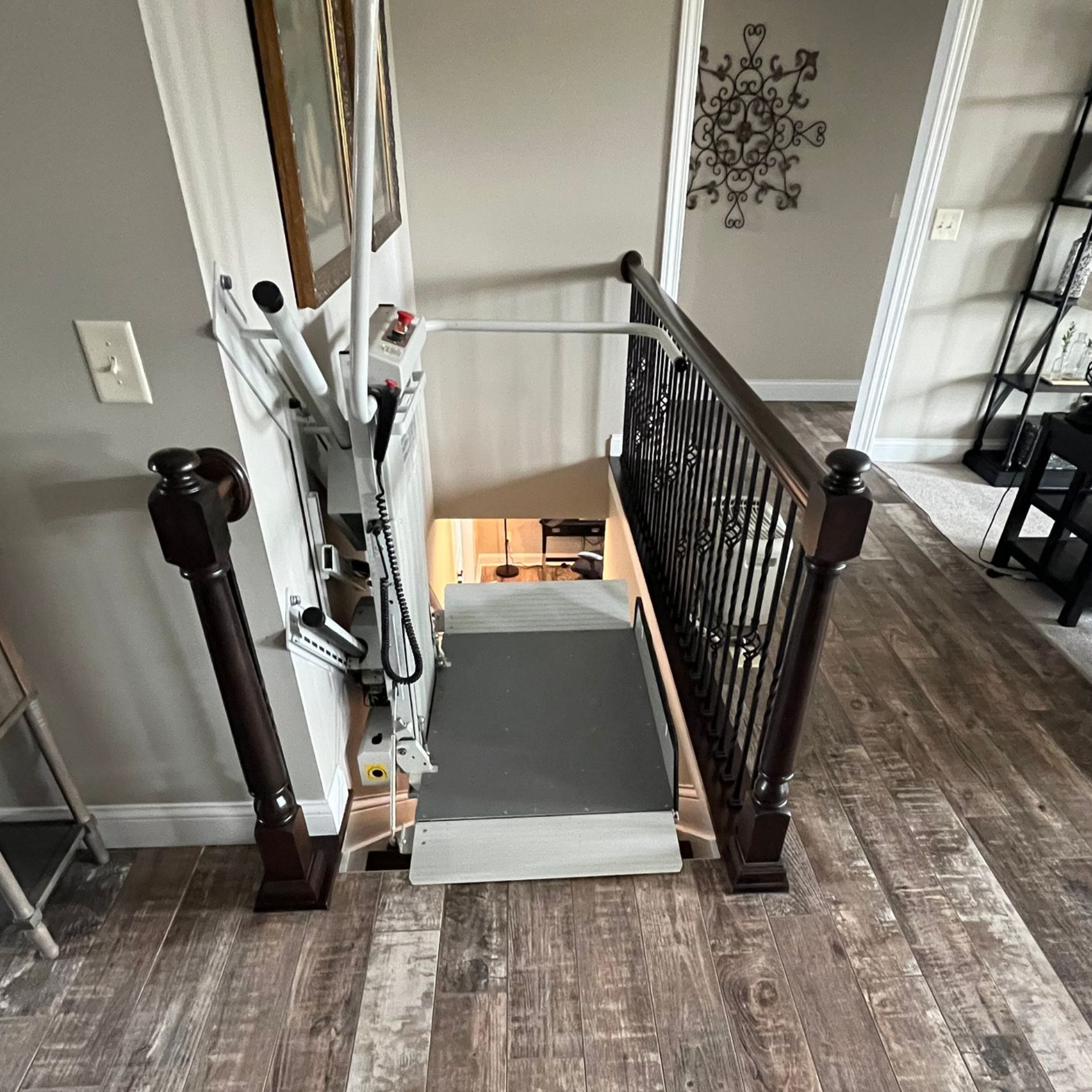 A white chair is sitting on the stairs in a living room