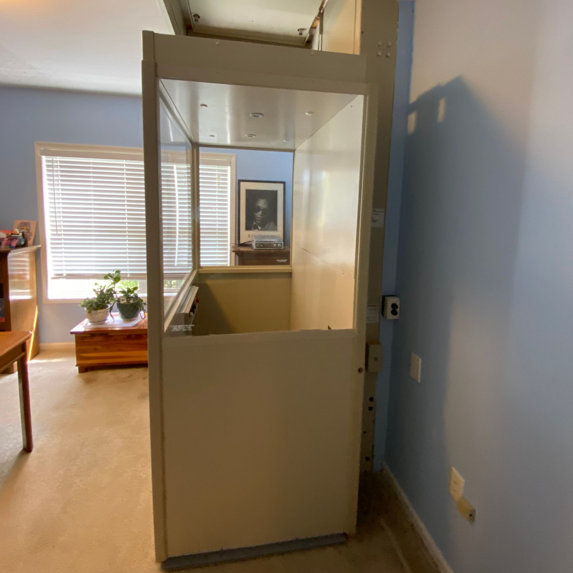 A stair lift is sitting next to a set of stairs