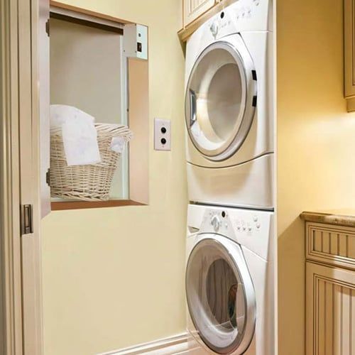 A laundry room with a washer and dryer stacked on top of each other.