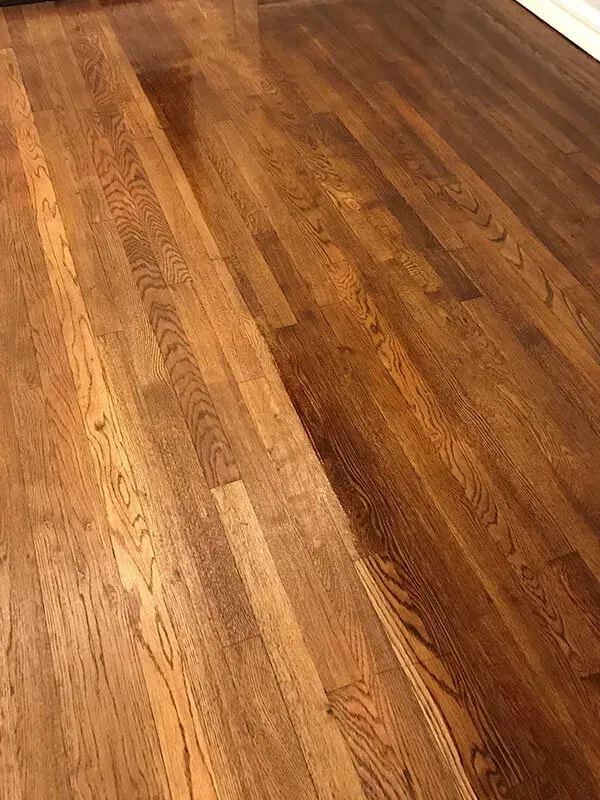 Wooden hardwood floor, diagonally lit, showing the grain and varied color tones