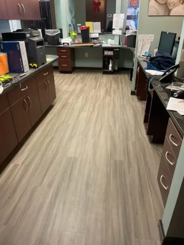 Office interior with gray wood-look flooring