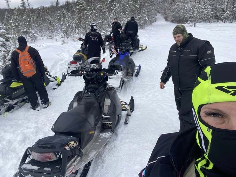a group of snowmobiles are lined up in the snow