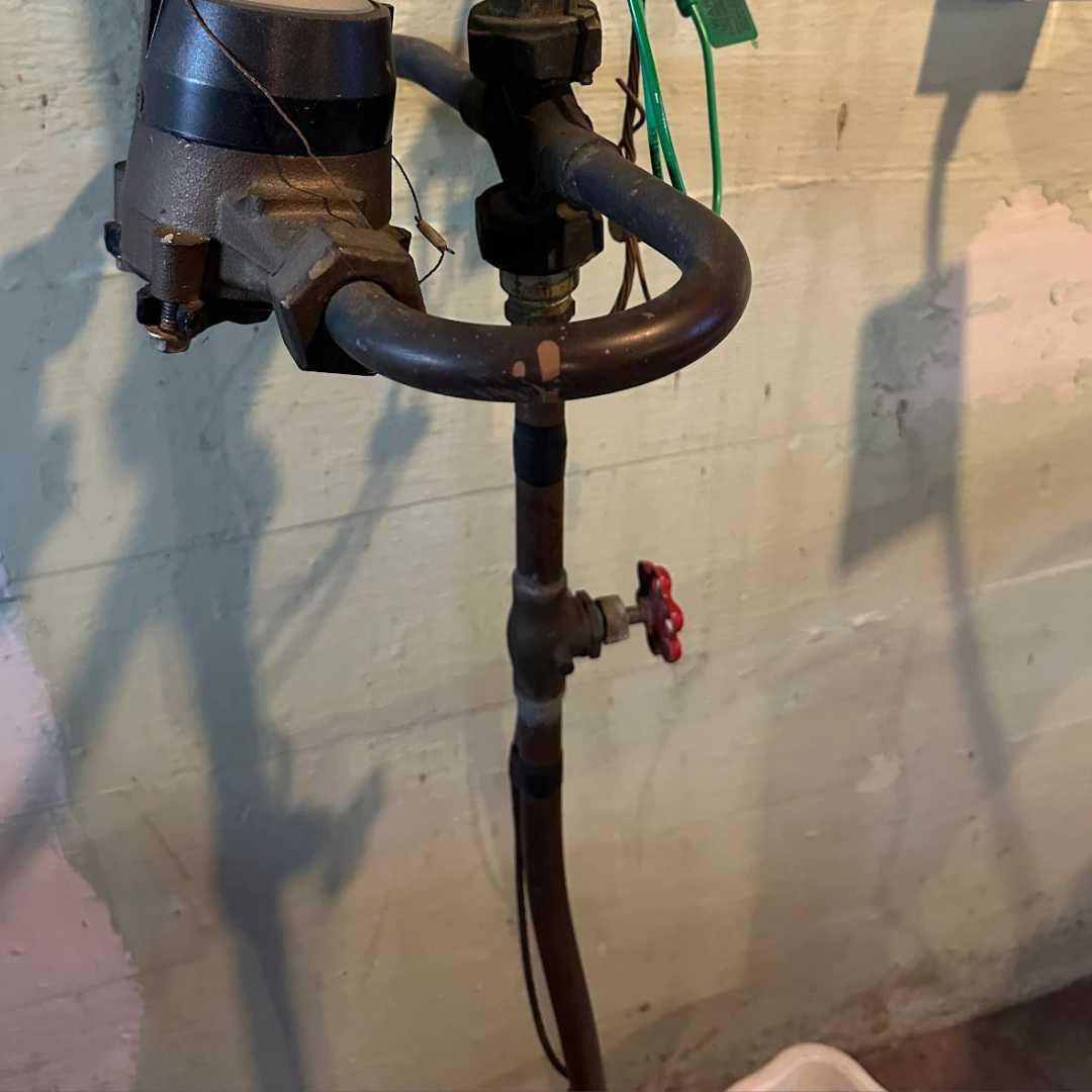 A pipe with a red valve attached to it