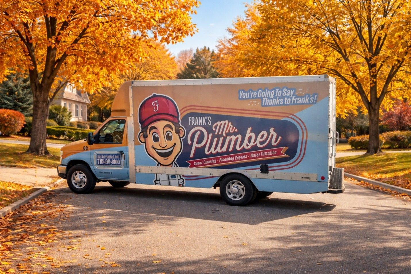 Mr. Plumber service van parked on a paved driveway with autumn trees in the background.
