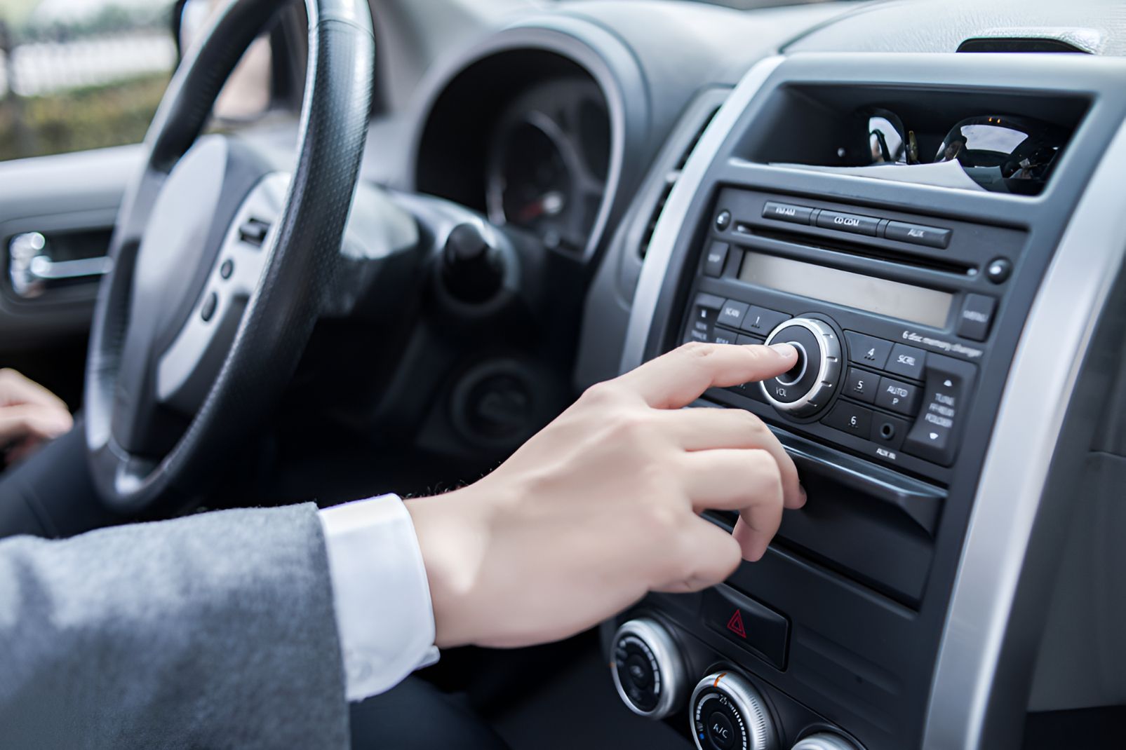 A Person is Adjusting the Radio in a Car — Auto Blue Service Centre In Bungalow, QLD