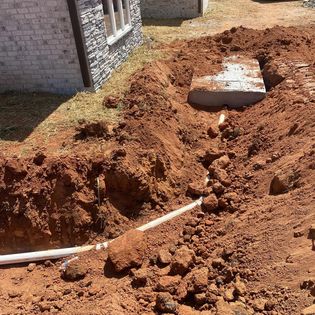 Pipe With Rocks And Soil — Belton, SC — Tractor Works LLC