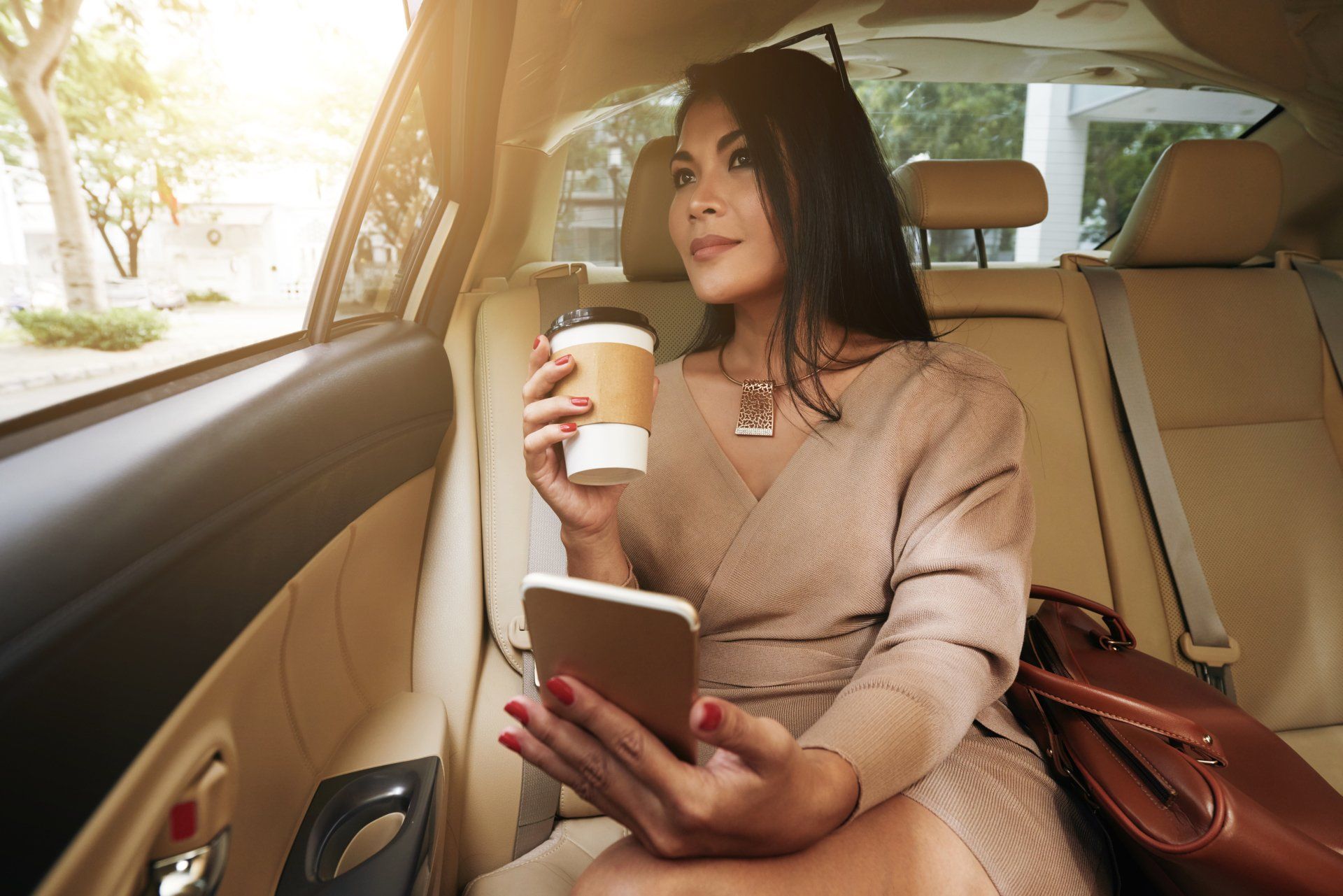 Marietta Taxi —  Gorgeous Woman Drinking Take-out Coffee When Riding to Work in Marietta, Ga
