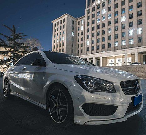 White Car Infront Of Building — Marco Island, FL — A Class Transportation White Car Infront Of Building — Marco Island, FL — A Class Transportation