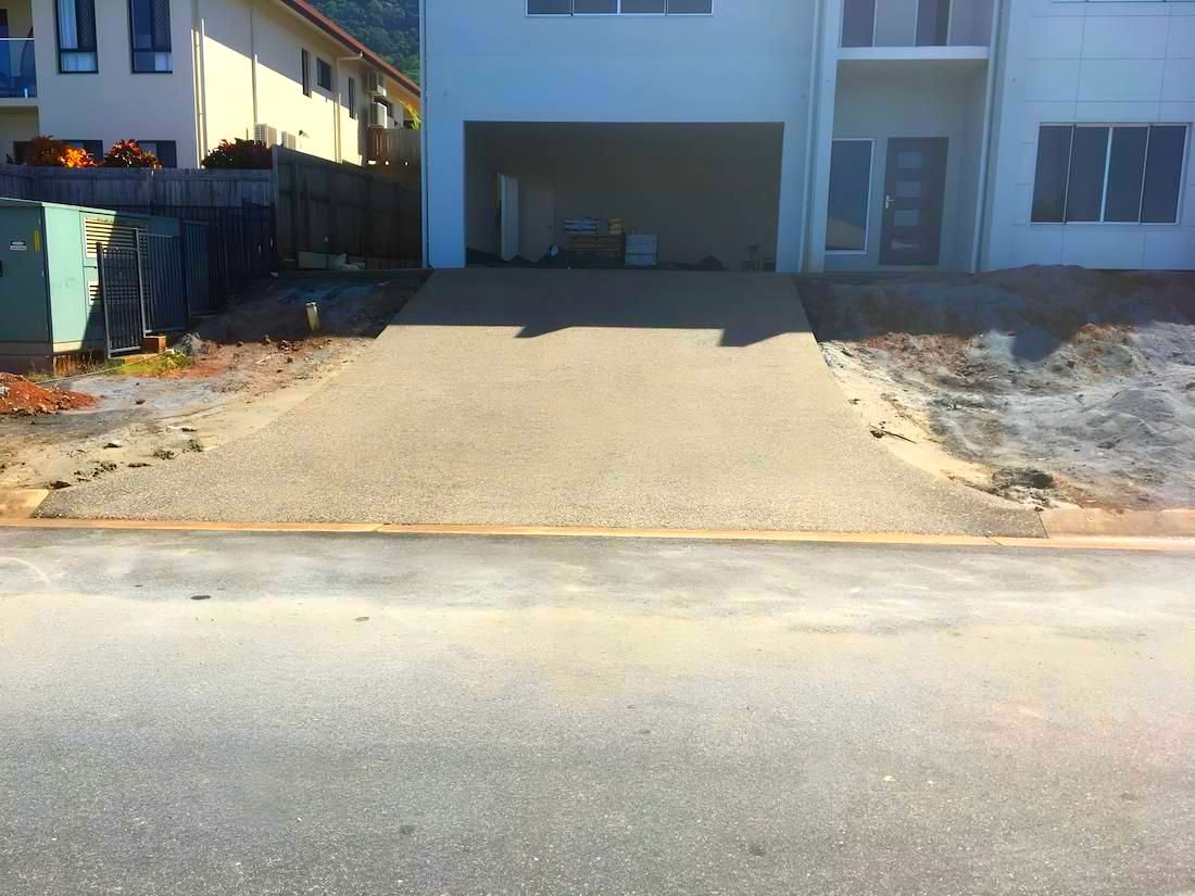 A Driveway Leading To A House With A Garage — Tropical North Concreting In Trinity Park, QLD