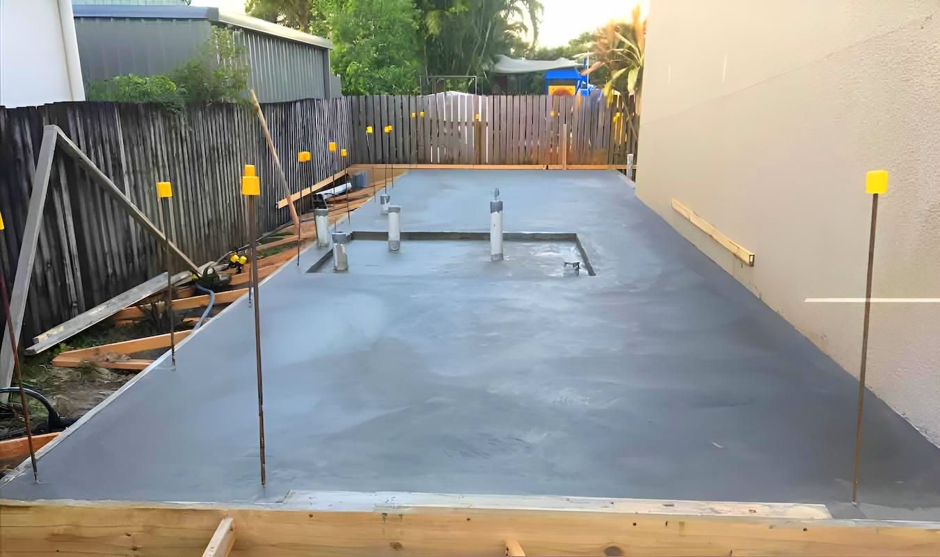 A Concrete Driveway Is Being Built In Front Of A House — Tropical North Concreting In Trinity Park, QLD