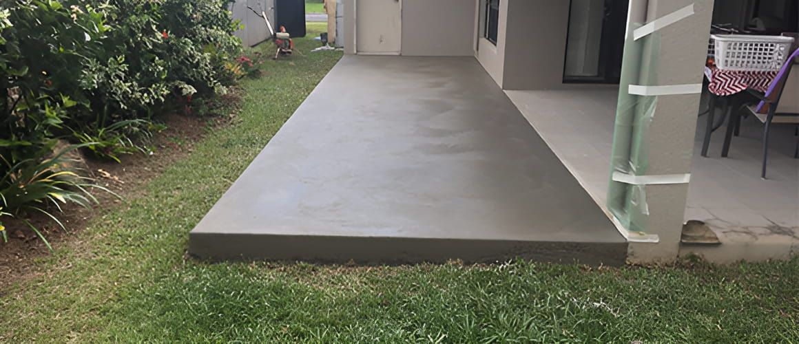 A Concrete Walkway Leading To A House In The Backyard — Tropical North Concreting In Trinity Park, QLD