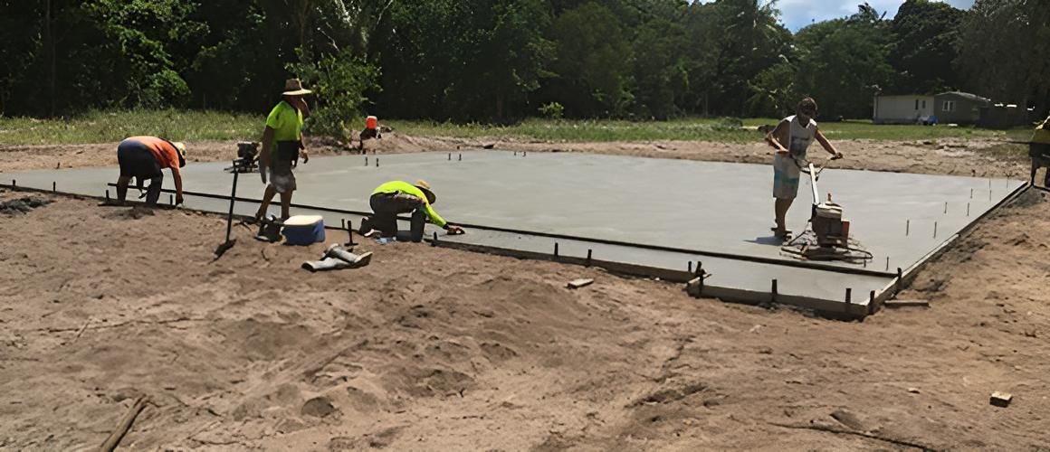 A Group Of Construction Workers Are Working On A Concrete Slab — Tropical North Concreting In Trinity Park, QLD