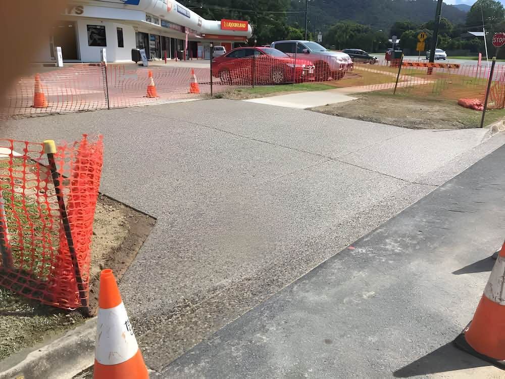 A Lot Of Traffic Cones Are On The Side Of The Road — Tropical North Concreting In Trinity Park, QLD