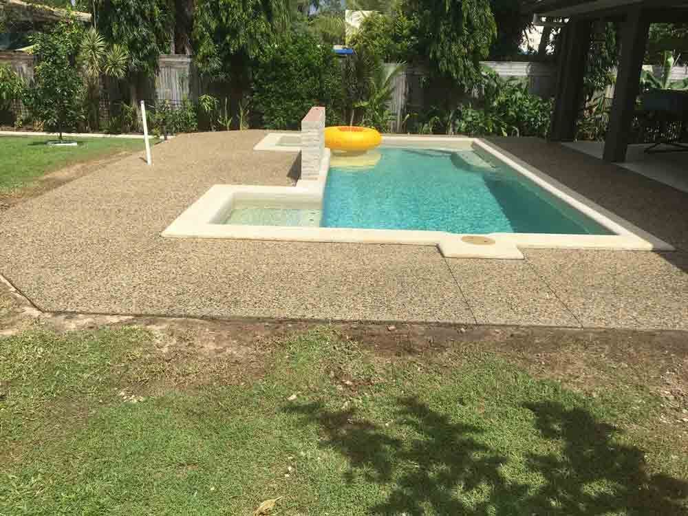 A Large Swimming Pool With a Yellow Life Preserver in the Water — Tropical North Concreting In Trinity Park, QLD