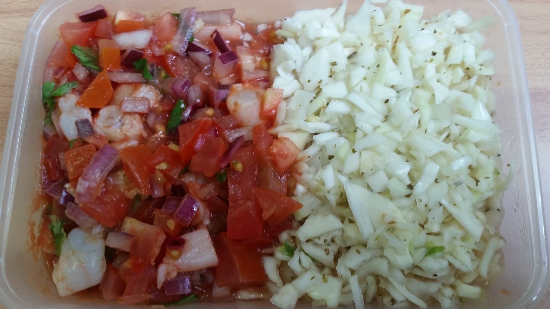 Container divided, showing chopped tomatoes and red onion salsa on the left, shredded cabbage on the right.