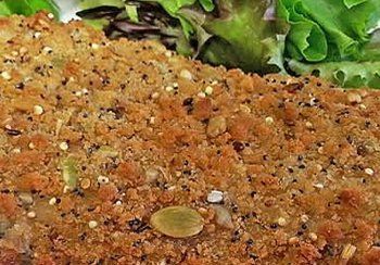 Close-up of baked bread with seeds and greens.