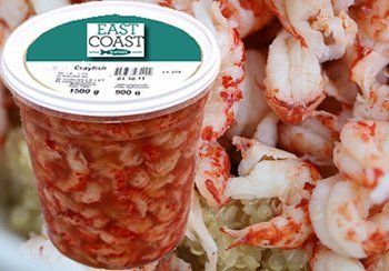 Container of cooked crayfish meat and a pile of crayfish meat.