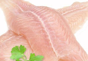 Raw fish fillets, pale pink, with visible muscle fibers. Parsley garnish.