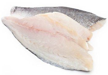 Raw fish fillets with light colored flesh and dark skin, on a white surface.