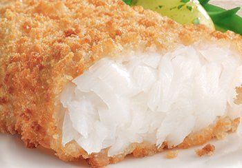 Close-up of a breaded and fried fish fillet, showing flaky white flesh and golden crust.