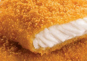 Close-up of a crispy, breaded fish filet, revealing white, flaky fish.