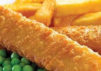 Fish and chips with peas; close up of battered fish, fries, and green peas.