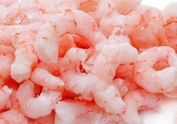 Pile of cooked, pink shrimp.