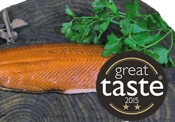 Smoked salmon fillet on wood, with parsley and a Great Taste 2015 award badge.
