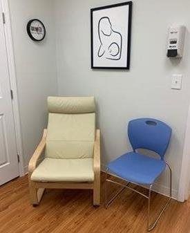 A chair and a blue chair in the corner of the room at Riverside Pediatrics.