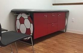 A soccer ball on the side of the table at Riverside Pediatrics.