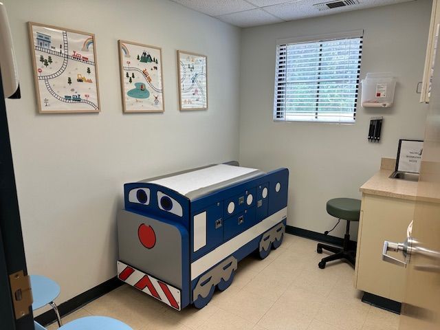 A pediatrician's office with an exam table in the shape of a train at Riverside Pediatrics.