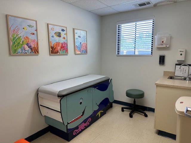A pediatrician's office with a whale shaped examination table at Riverside Pediatrics.