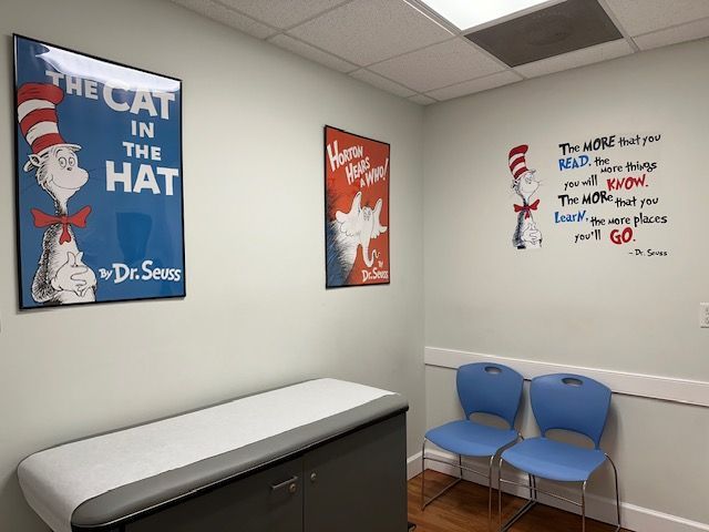 A doctor 's office at Riverside Pediatrics with a cat in the hat poster on the wall